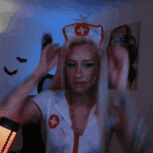 a woman in a nurse outfit has a red cross on her shirt