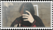 a blurred picture of a person taking a selfie with a cell phone .
