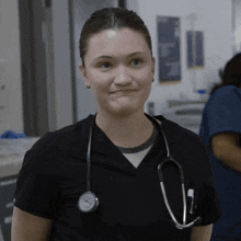 a nurse with a stethoscope around her neck is making a face
