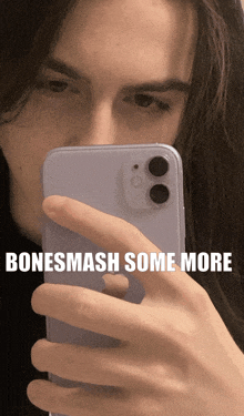a man taking a picture of himself with the words bonesmash some more above him