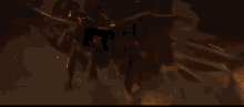 a person is standing in front of a burning building at night .