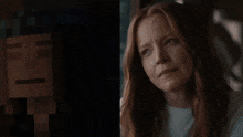 a woman with red hair is crying next to a pixelated image of a man
