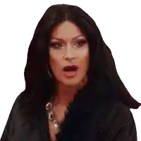 a woman with long black hair is wearing a black fur coat and a necklace
