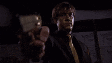 a man with gold paint on his face holds a gun