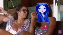 two women are sitting on a couch and one of them has a picture of a girl with blue hair on her face