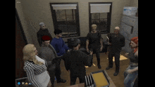 a group of people are gathered in a room with a box on the floor that says ' a ' on it