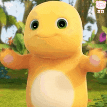 a yellow stuffed animal with green eyes is standing in the grass with its arms outstretched