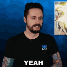a man with a beard wearing a black t-shirt that says yeah