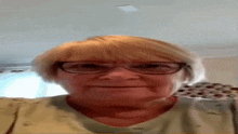 an older woman wearing glasses and a green shirt is making a funny face