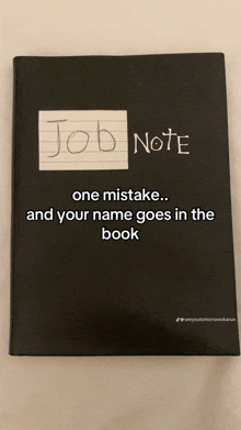 a black notebook with a sticker on it that says job note