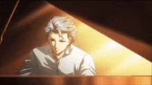 a man in a white shirt is sitting in front of a piano .