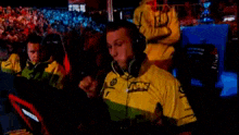 a man wearing a yellow shirt that says nbg on it