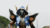 a blue and black robot with a hood on