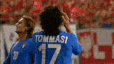 a soccer player wearing a blue shirt with the number 17 on it