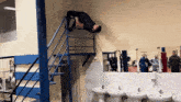 a man is doing a handstand in a gym