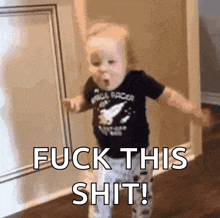 a baby is dancing in a room with the words fuck this shit written on it .