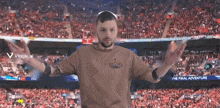 a man standing in front of a stadium with the words the final adventure on the bottom
