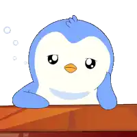 a blue and white penguin is sitting on a wooden table