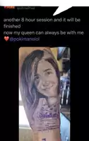 a woman has a tattoo of her face on her arm .