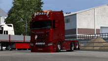 a red scania truck is parked in a parking lot
