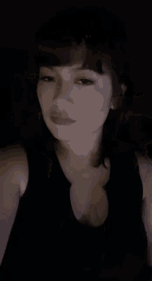 a close up of a woman 's face in a dark room