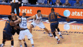 a basketball game is being played in front of an at & t ad