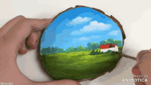 a person is holding a piece of wood with a painting on it that says wow art made in animatica
