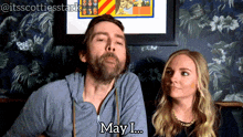 a man with a beard says may i..