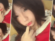 a girl in a santa suit is taking a selfie with her finger in her mouth