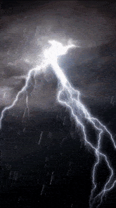 a lightning bolt strikes a dark cloudy sky in the rain
