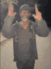 a man with a beard is wearing a jacket that says c on it