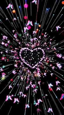 a heart shaped firework display with butterflies flying around it