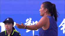 a woman is holding a tennis racquet in her hand