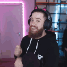 a man wearing headphones and a cat ear headband
