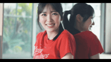 a woman wearing a red t-shirt that says always feelings