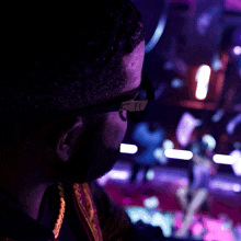 a man wearing glasses is looking at something