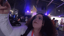 a woman taking a selfie in front of a logitech sign