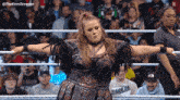 a woman in a wrestling ring with the word eagles on her sweatshirt