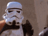 a close up of a storm trooper 's helmet and arms