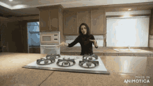 a woman stands in a kitchen with the words made in animatica on the bottom of the screen