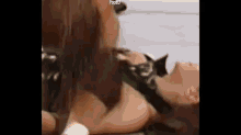 a couple of people are laying on top of each other .