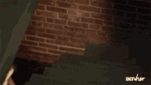 a brick wall is behind a set of stairs with the words bet her on the bottom