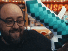 a bald man wearing glasses is holding a piece of paper that says misp on it