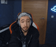 a man wearing headphones is sitting in front of a piano