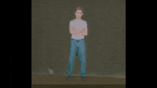 a person is standing in front of a green screen and talking on a cell phone .