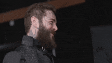 a man with a beard has a tattoo on his forehead that says " n "