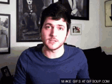 a man in a blue shirt says make gifs at gifsoup.com on the bottom right