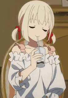 a girl with blonde hair is drinking through a straw .
