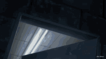 a dark room with a light shining through a doorway and a sign that says ' ain ' on it