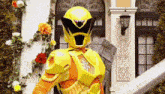 a yellow ranger is standing in front of a building